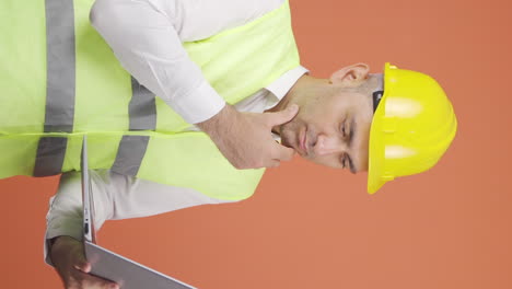 Vertical-video-of-Engineer-working-on-project-on-laptop.